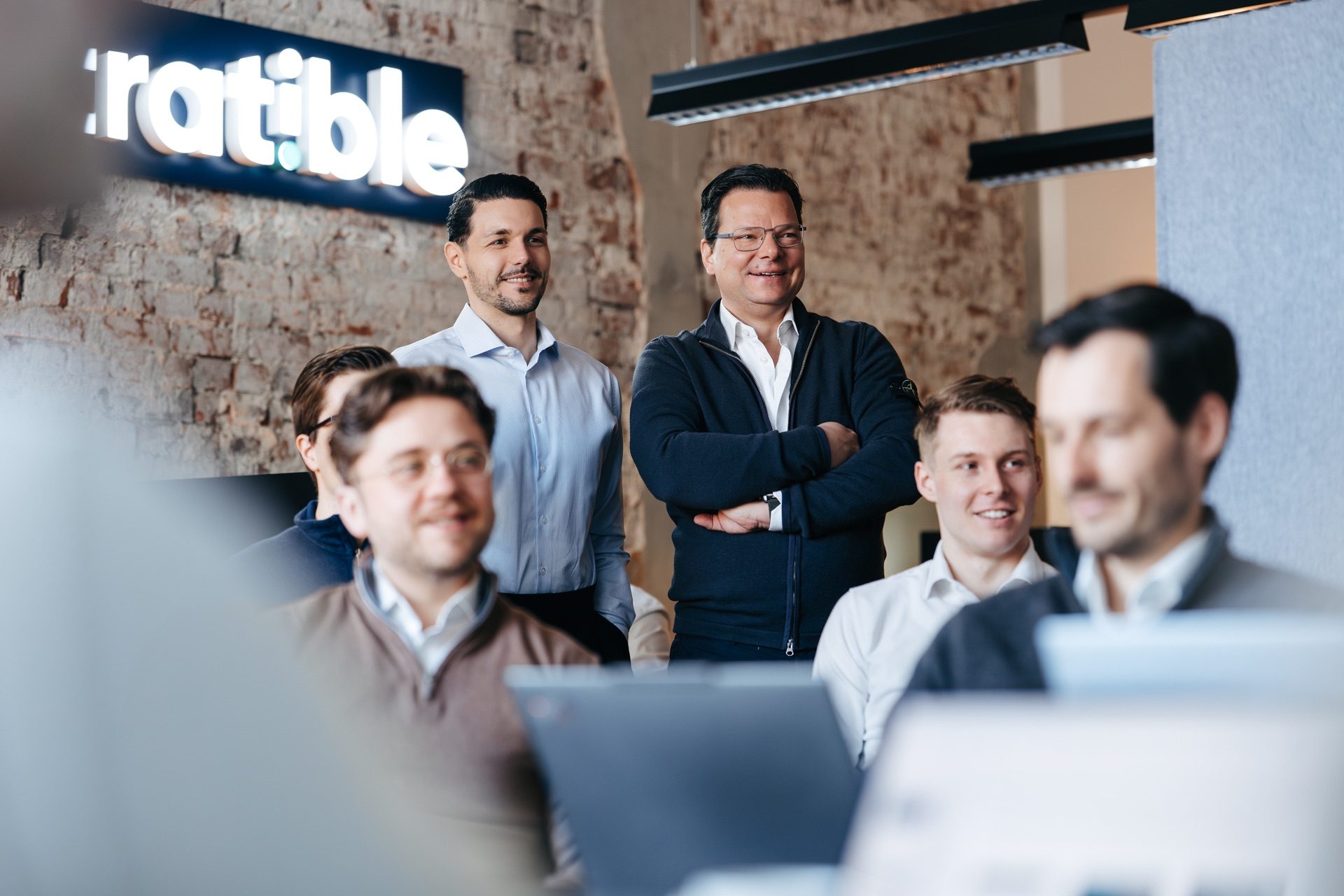 Kerim Cekel und Thorsten Schramm vor dem stratible Logo mit dem Team
